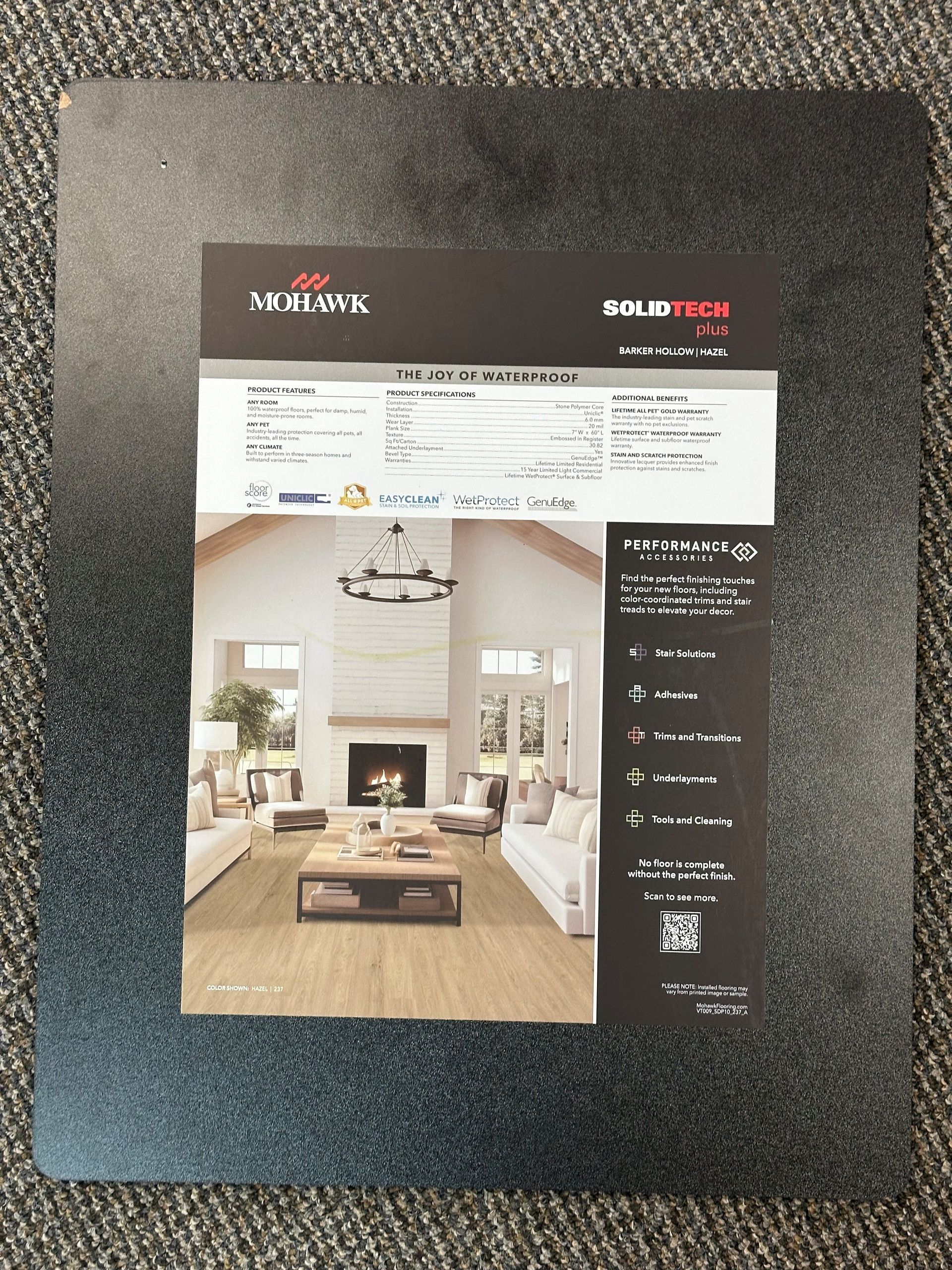 Floor sample with product information, featuring a living room photo and specifications on a dark textured surface.