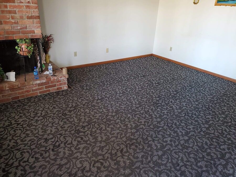 Staircase with light carpet leading upwards against a light gray wall.