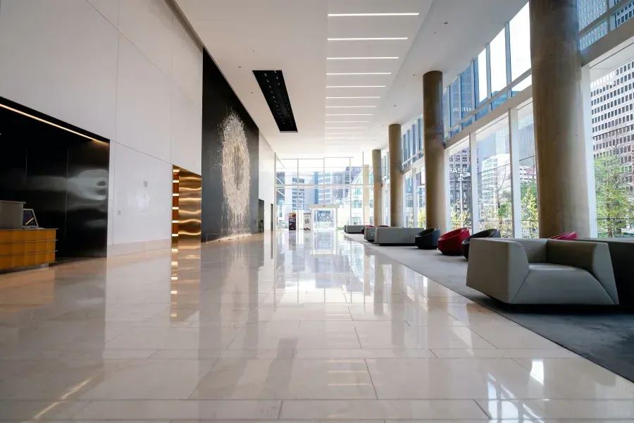A large lobby with a lot of windows and chairs.