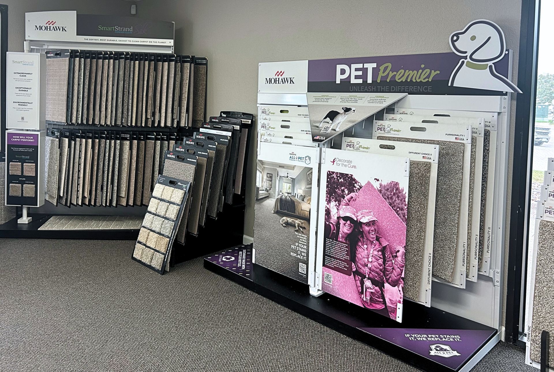 Carpet display with samples in a showroom. Pet-friendly options are featured.
