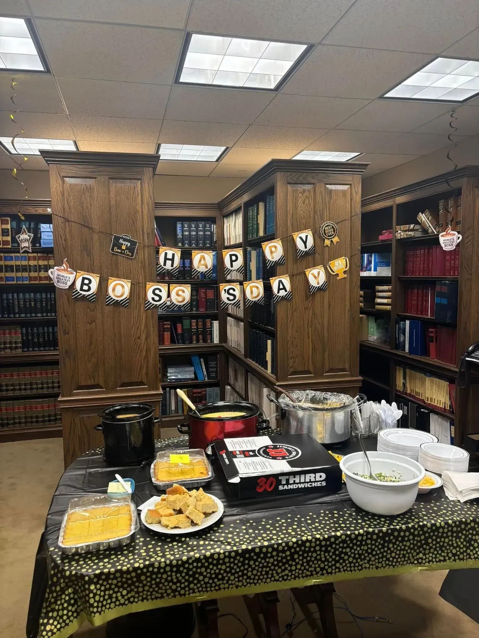 Birthday celebration: Food spread on a table in a library, decorated with a
