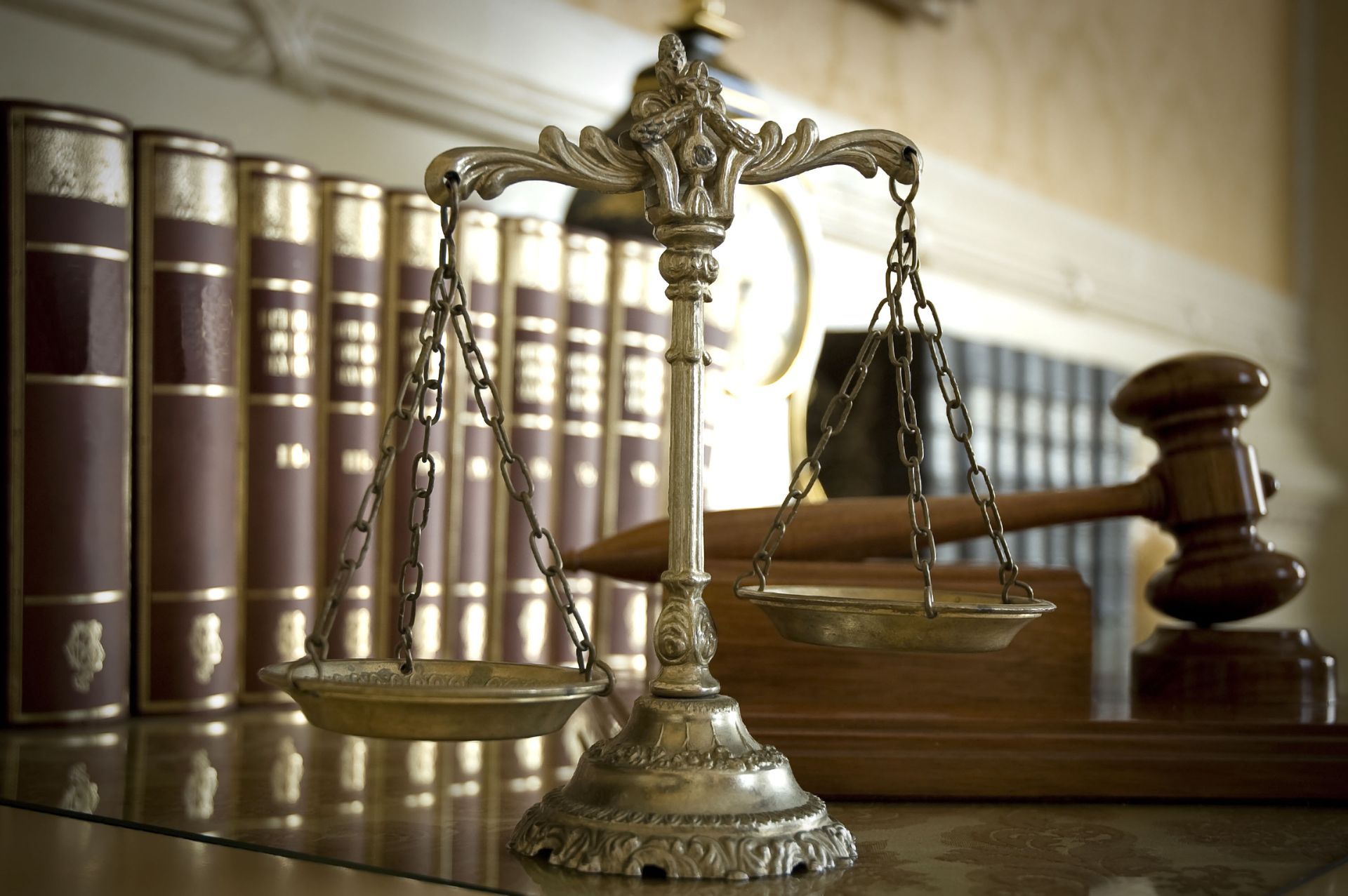 Scales of justice with books and gavel in a law office setting.