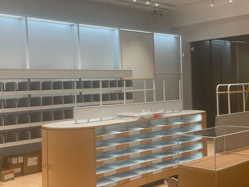A store with a lot of shelves and boxes on the floor