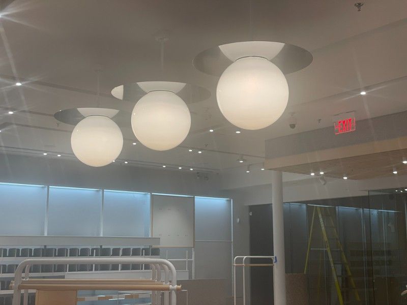 A room with a lot of lights hanging from the ceiling.