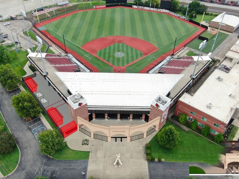 An aerial view of a baseball field with a large building in the foreground