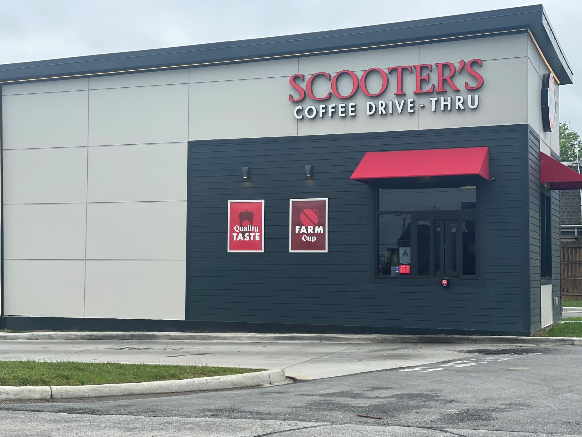 Scooter’s Coffee drive-thru storefront with red signs and black exterior siding