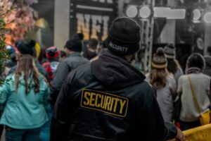 Security guard overlooking an urban area with tall buildings and trees.