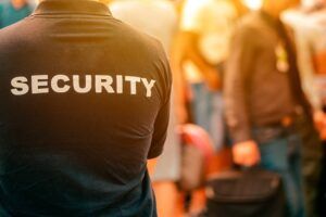 Security guard overlooking an urban area with tall buildings and trees.