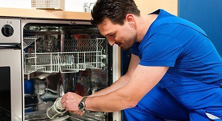 guy working on dishwasher