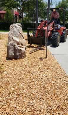 forklift with gravel-and-boulder