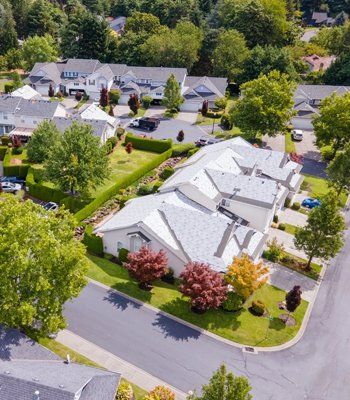 An aerial view of a residential area with houses and trees