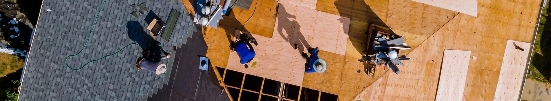 A group of people are standing on top of a wooden structure.