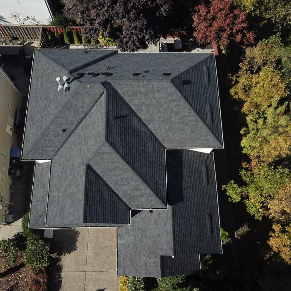 An aerial view of a house with a black roof