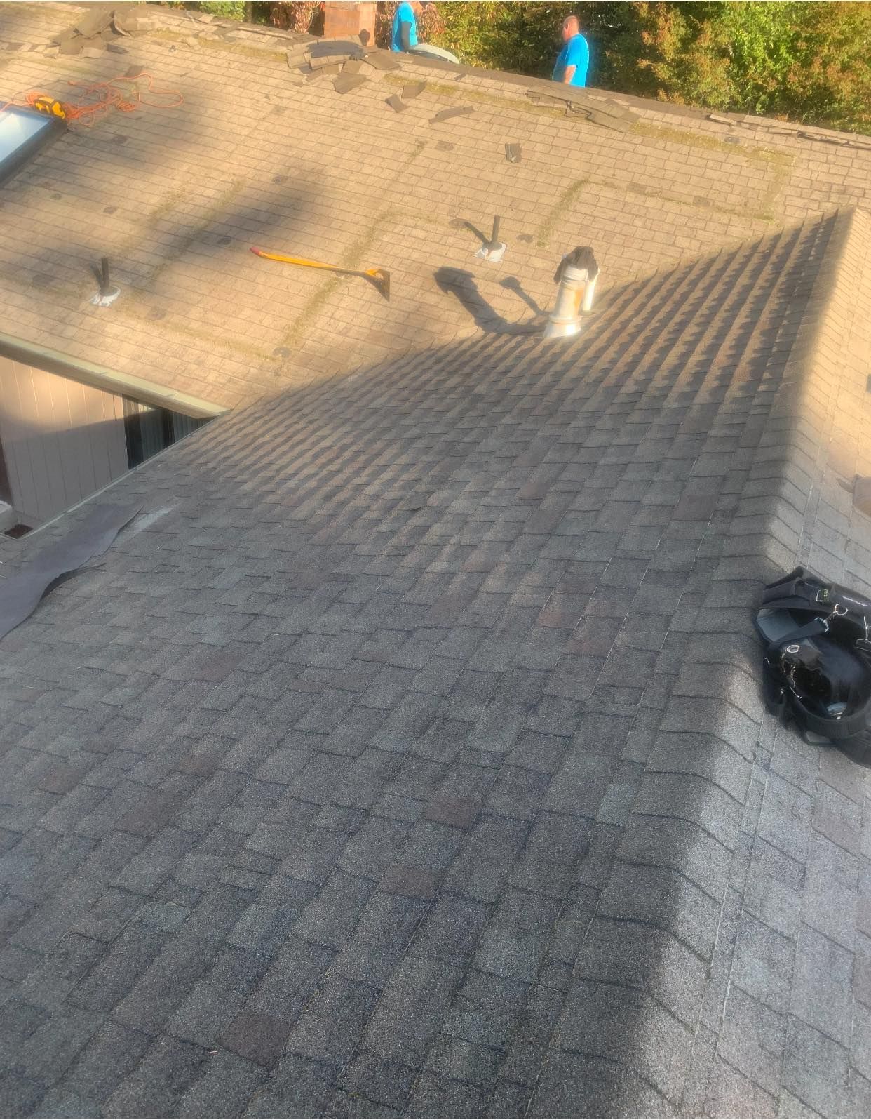 A camera is sitting on the roof of a house.