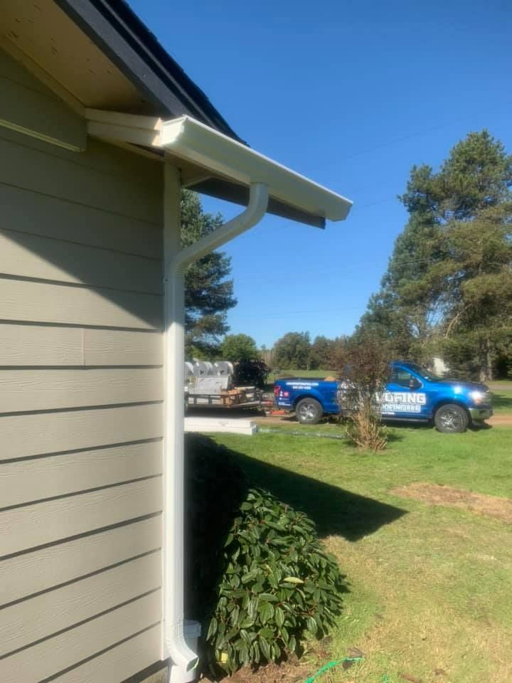 A blue truck is parked on the side of a house.