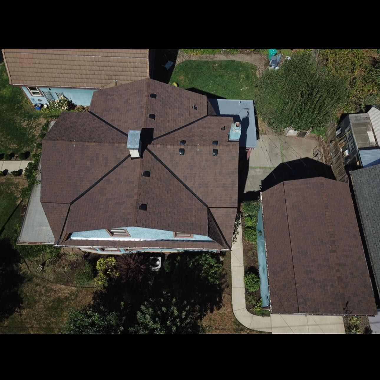 An aerial view of a house with a brown roof.