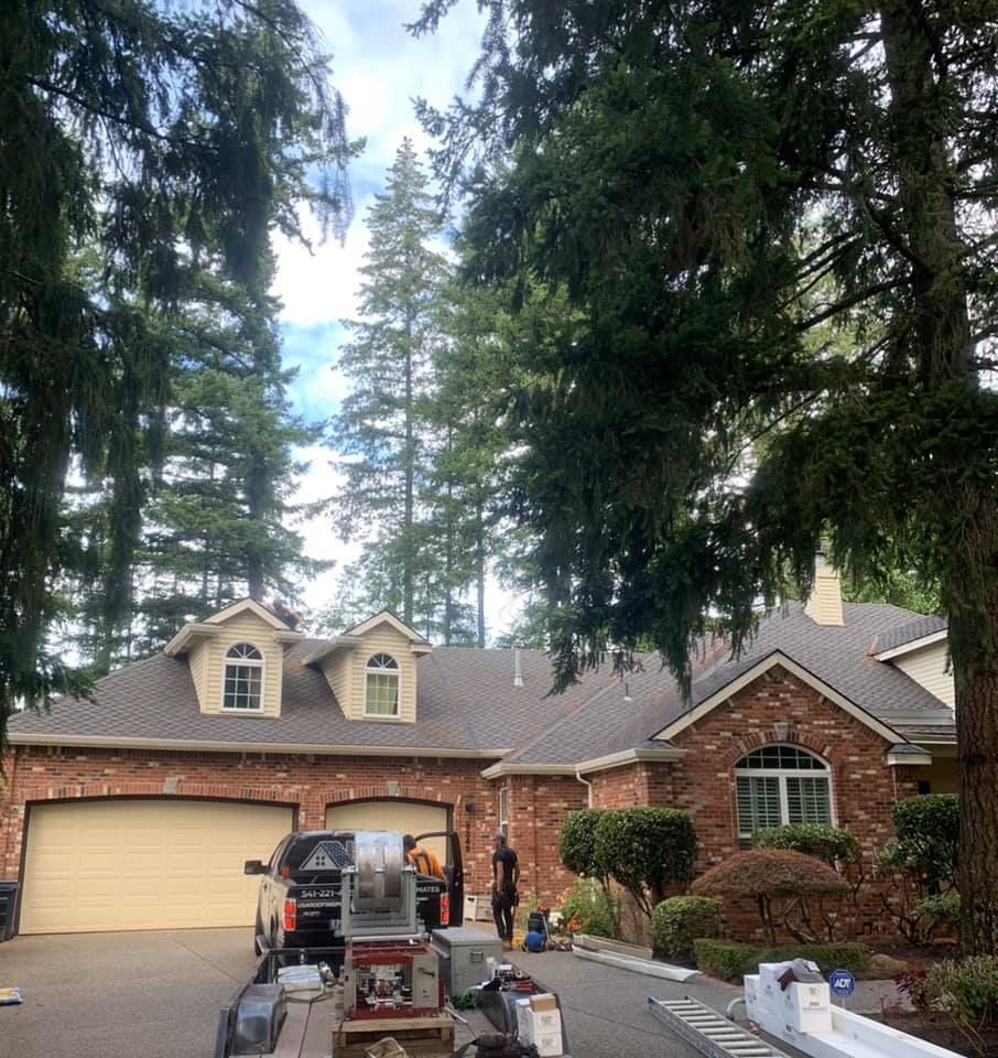 A truck is parked in front of a brick house.