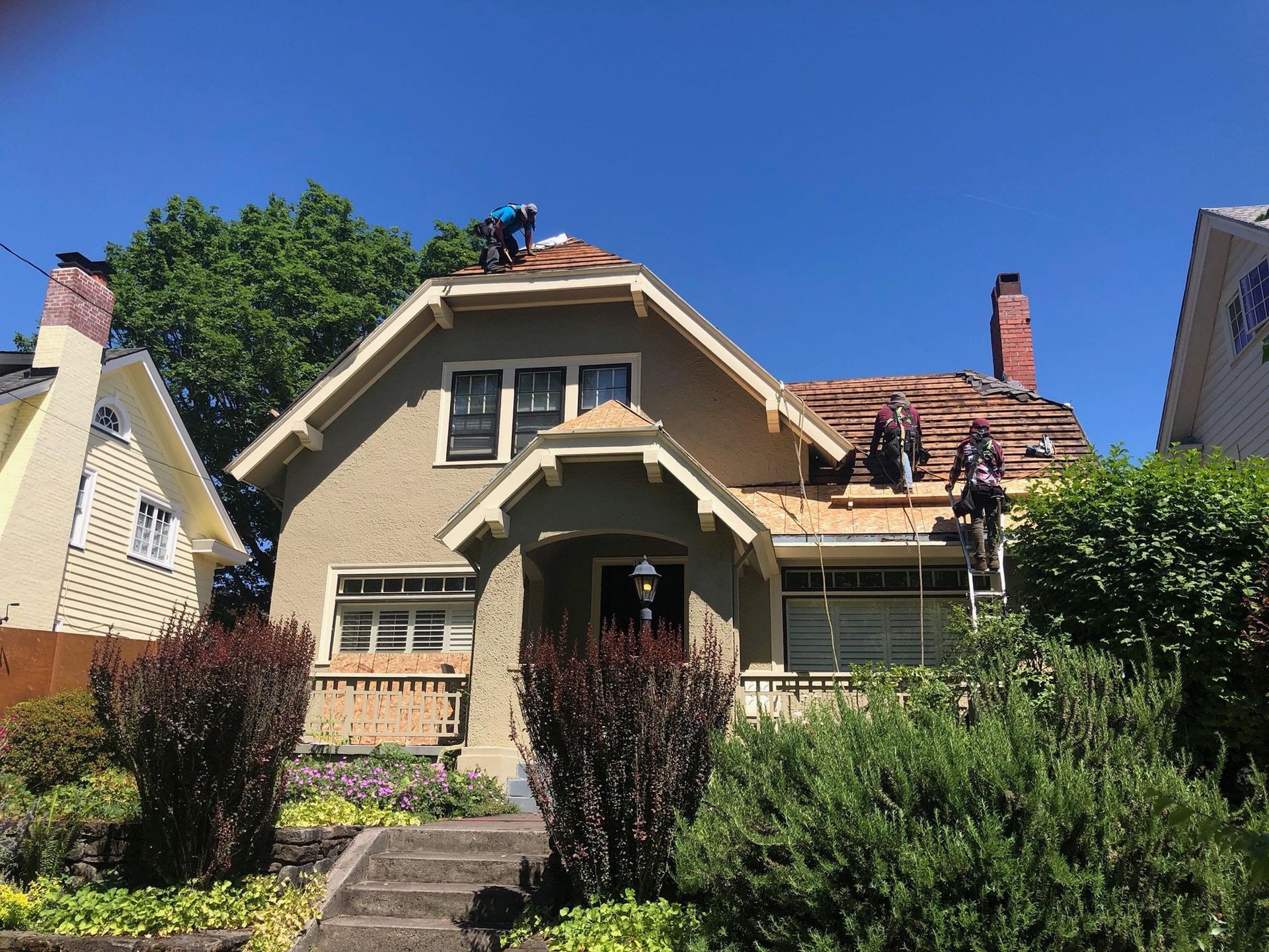 A house with a dog on the roof is being remodeled.
