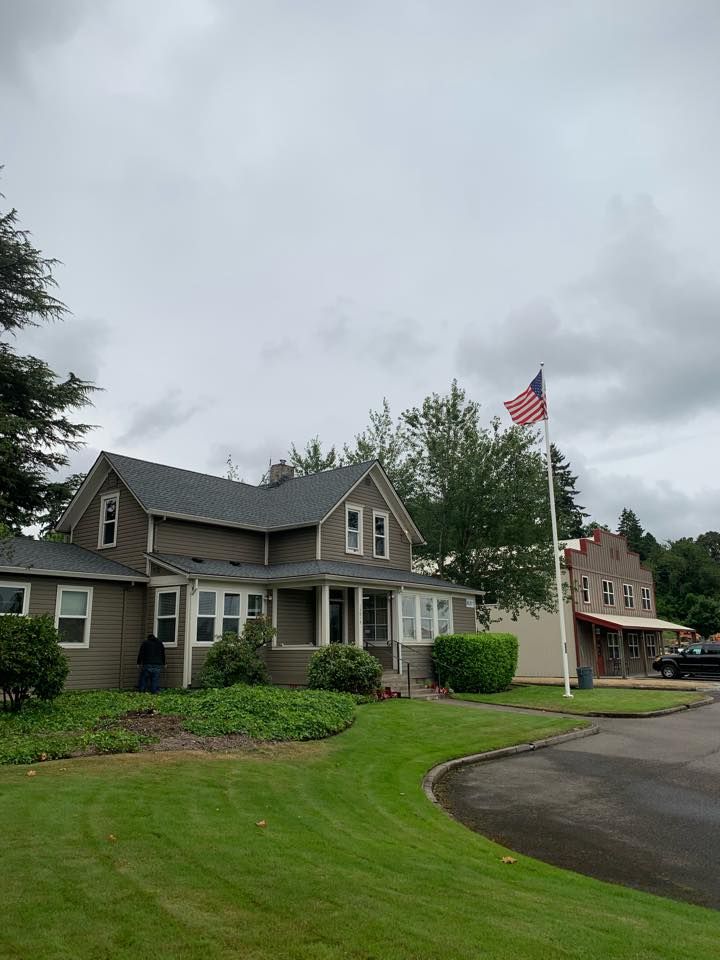 A house with a flag in front of it on a cloudy day.