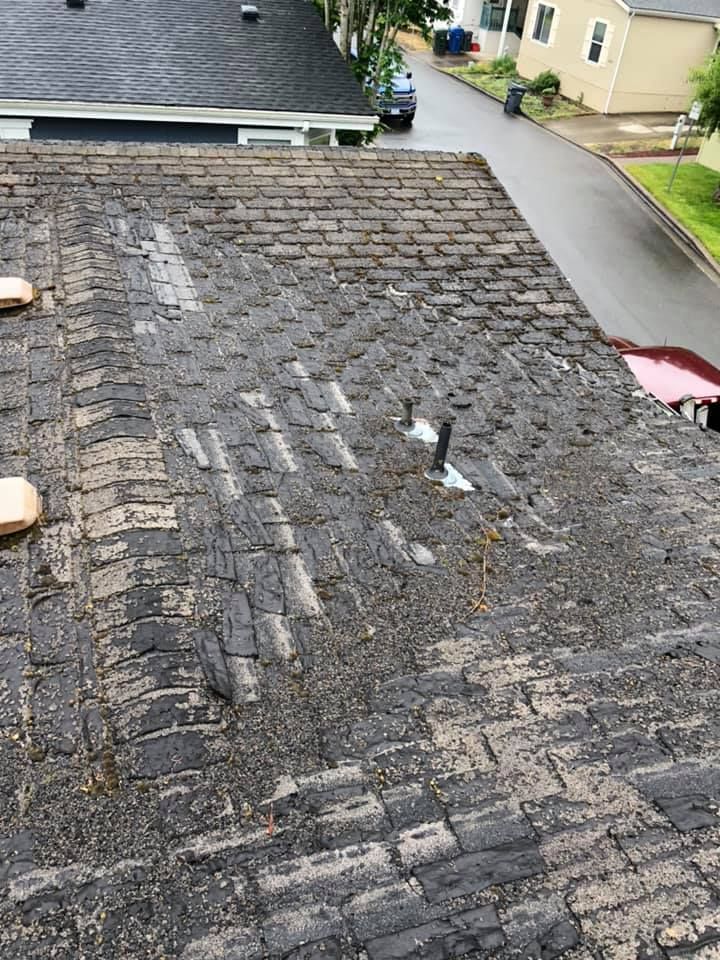 The roof of a house is very dirty and needs to be cleaned.