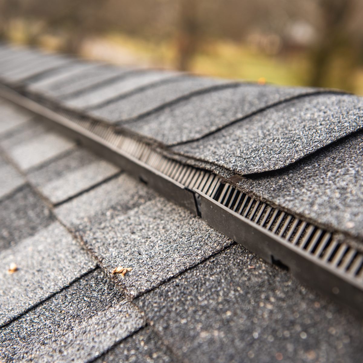 A close up of a roof with a drain on it.