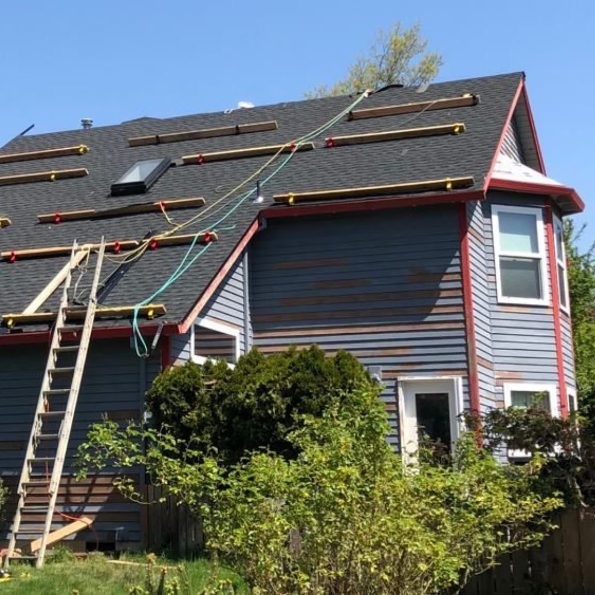 A house with solar panels being installed on the roof.