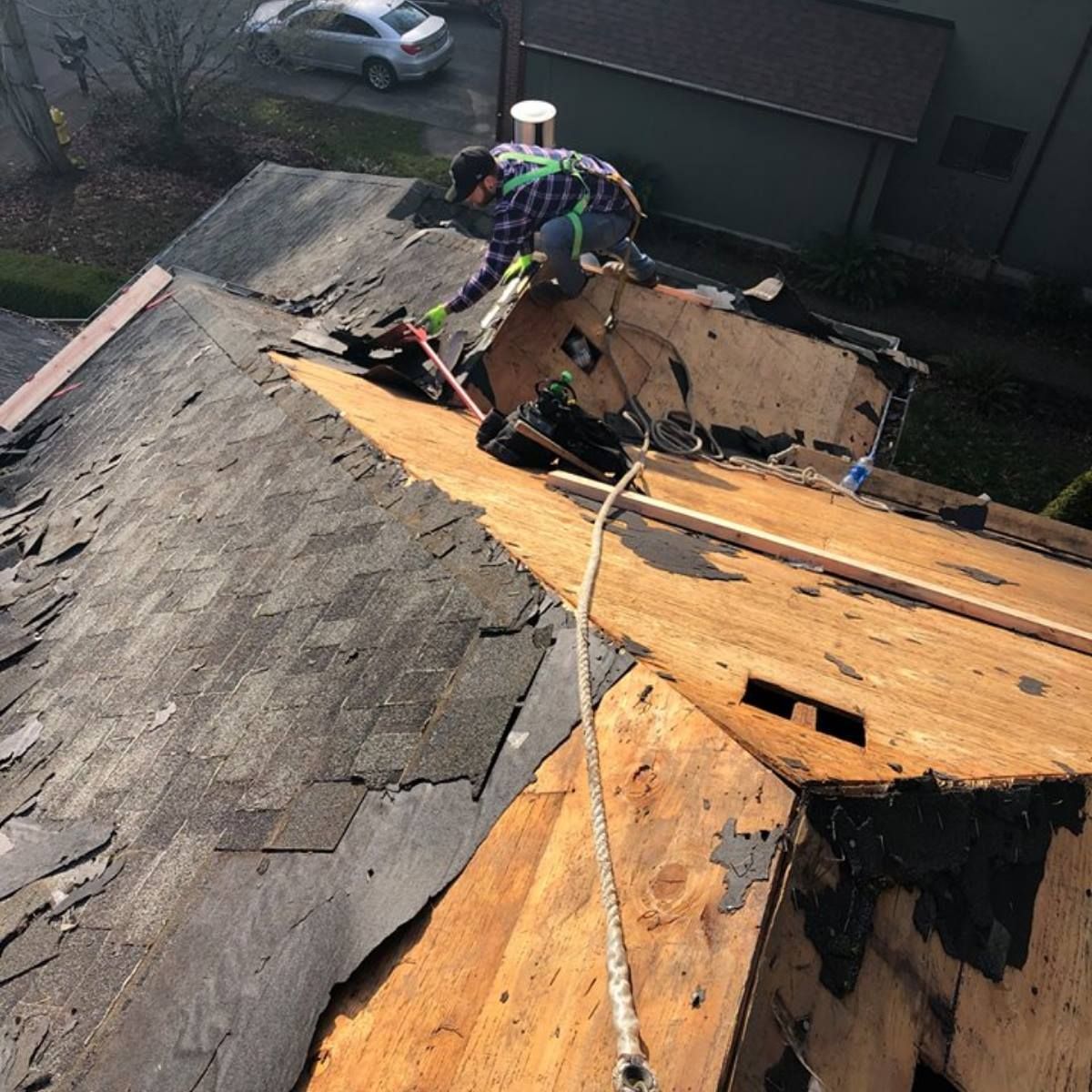 A man is working on the roof of a house