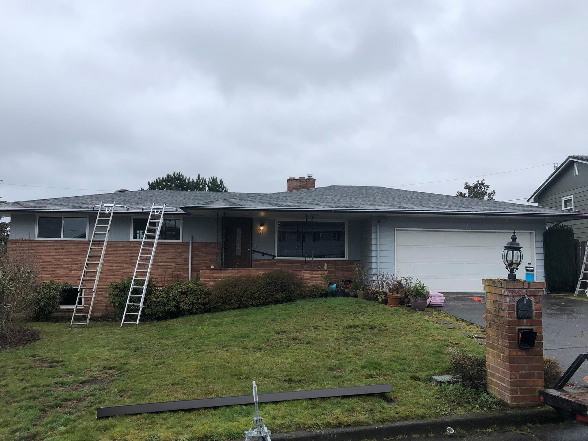 A house with a roof that is being installed on a cloudy day.