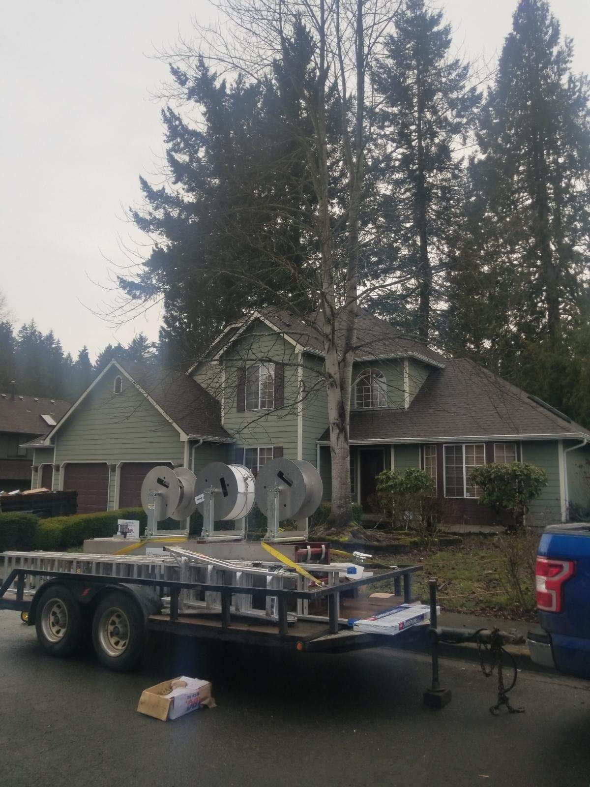 A trailer is parked in front of a house.