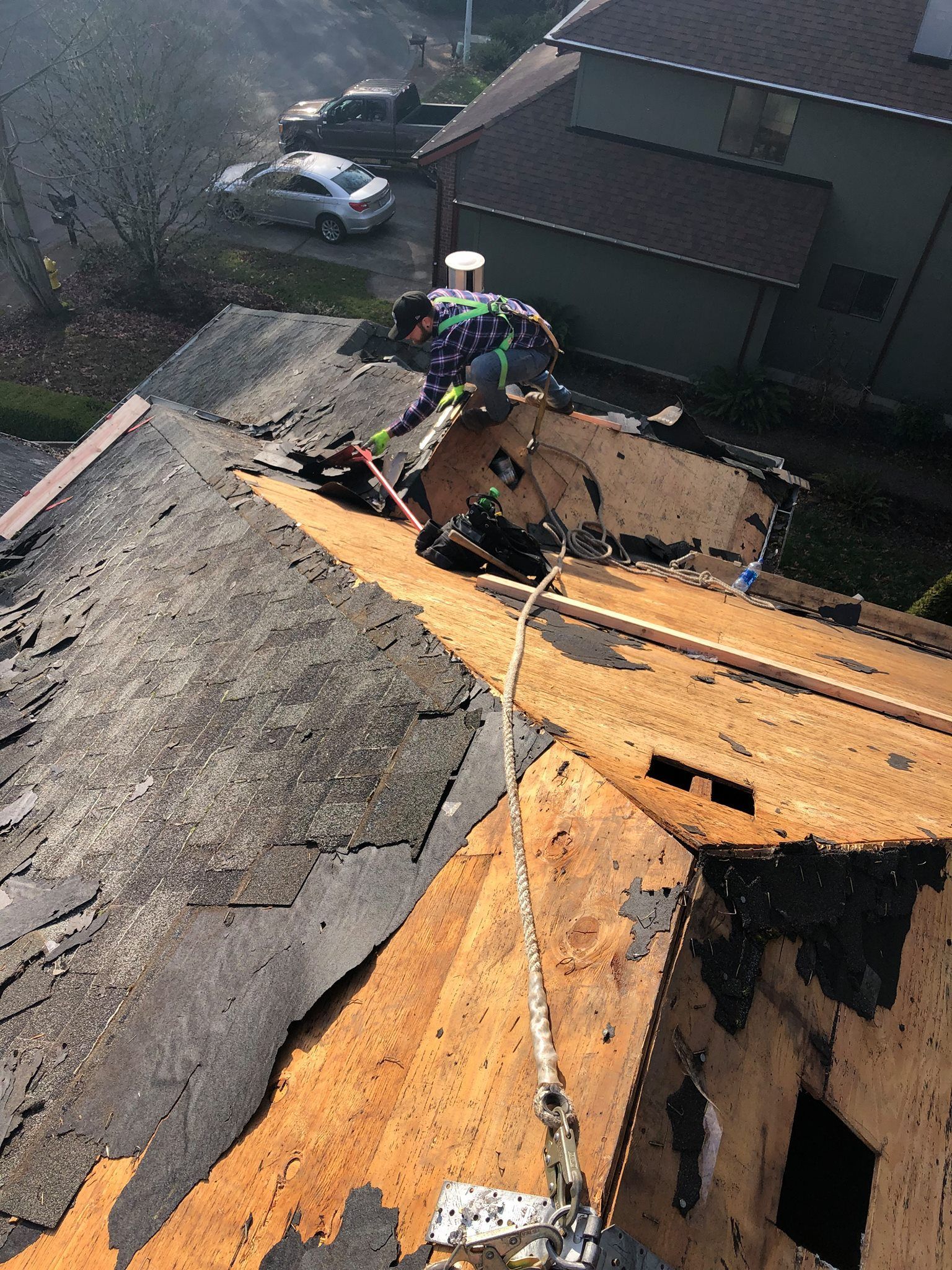 A man is working on the roof of a house.