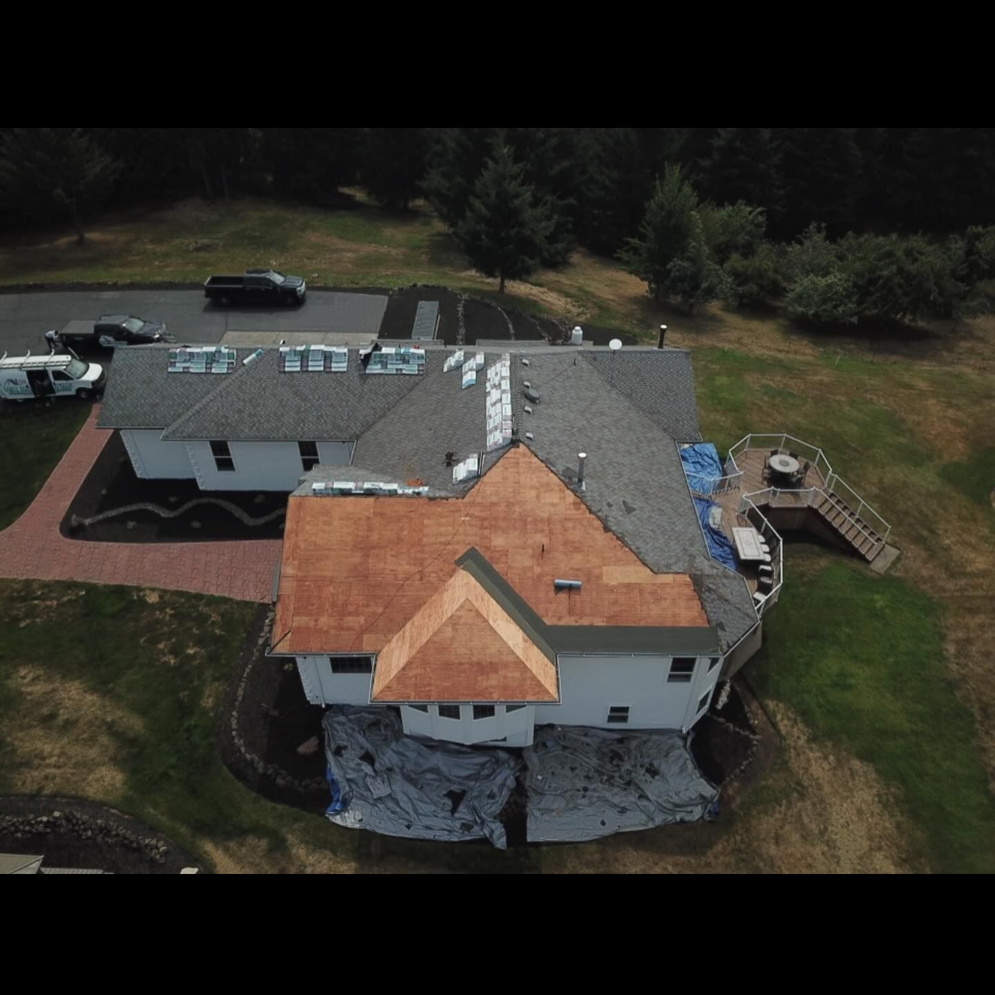 An aerial view of a house with a roof that is being installed.