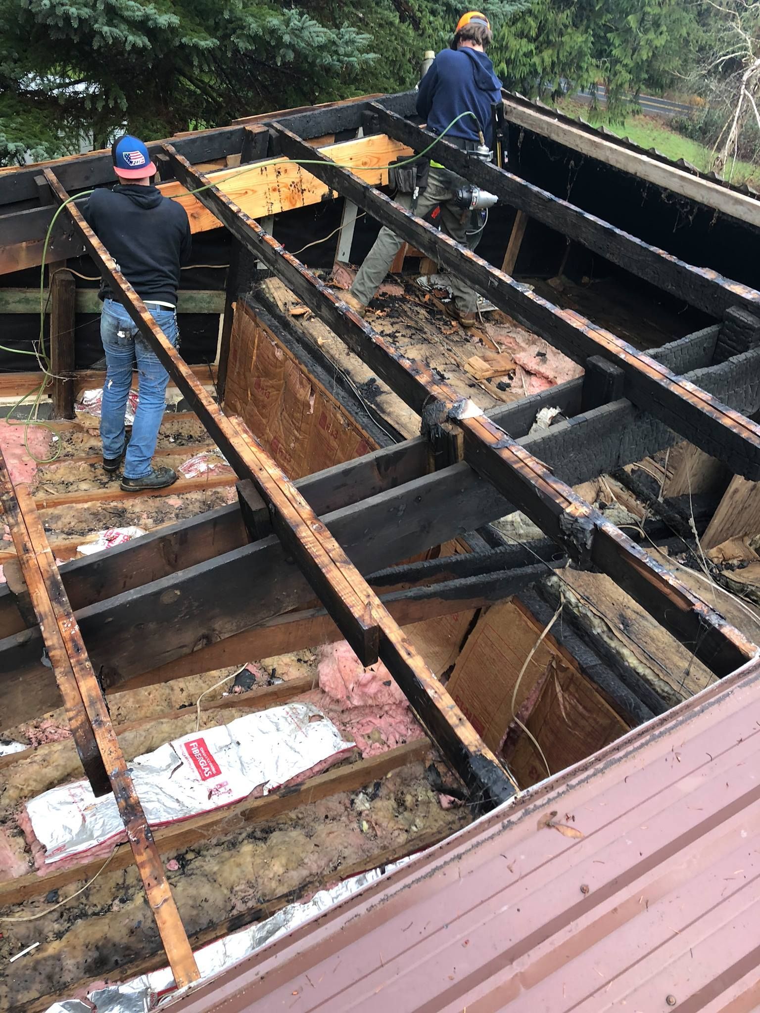 A group of men are working on the roof of a building.