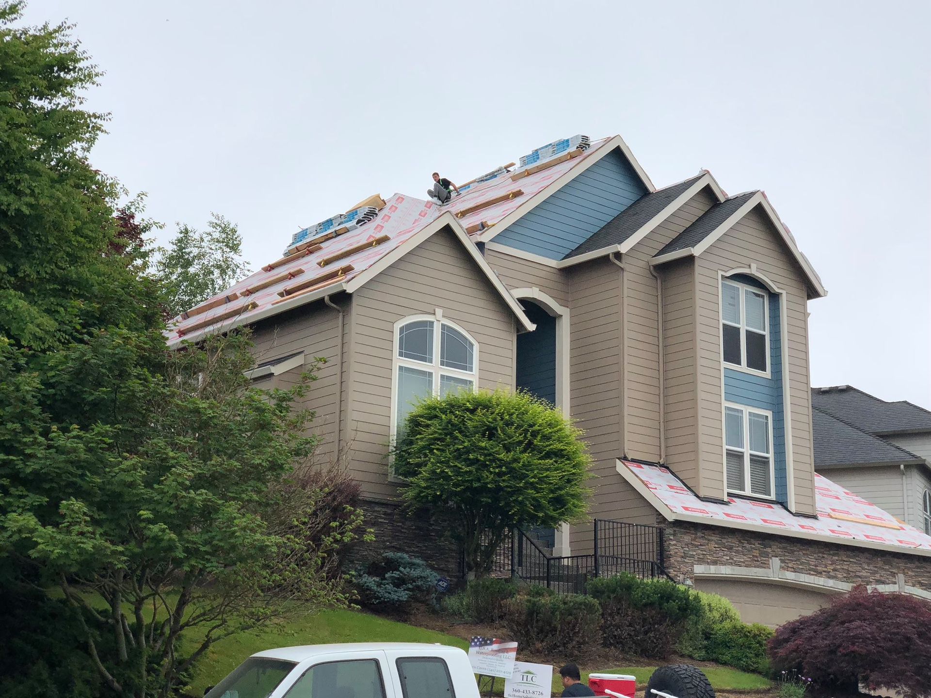 A large house with a truck parked in front of it.