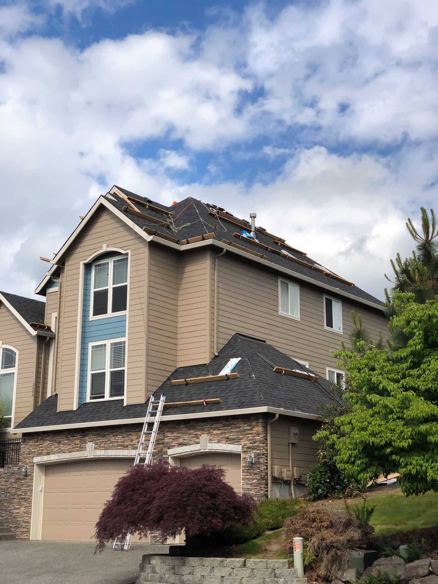A large house with a ladder on the side of it.
