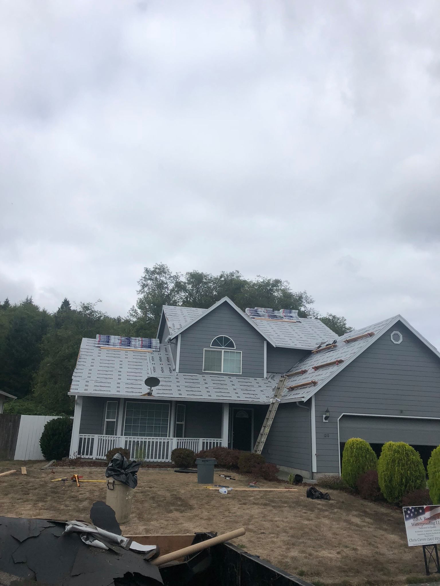 A large house with a roof that is being repaired.