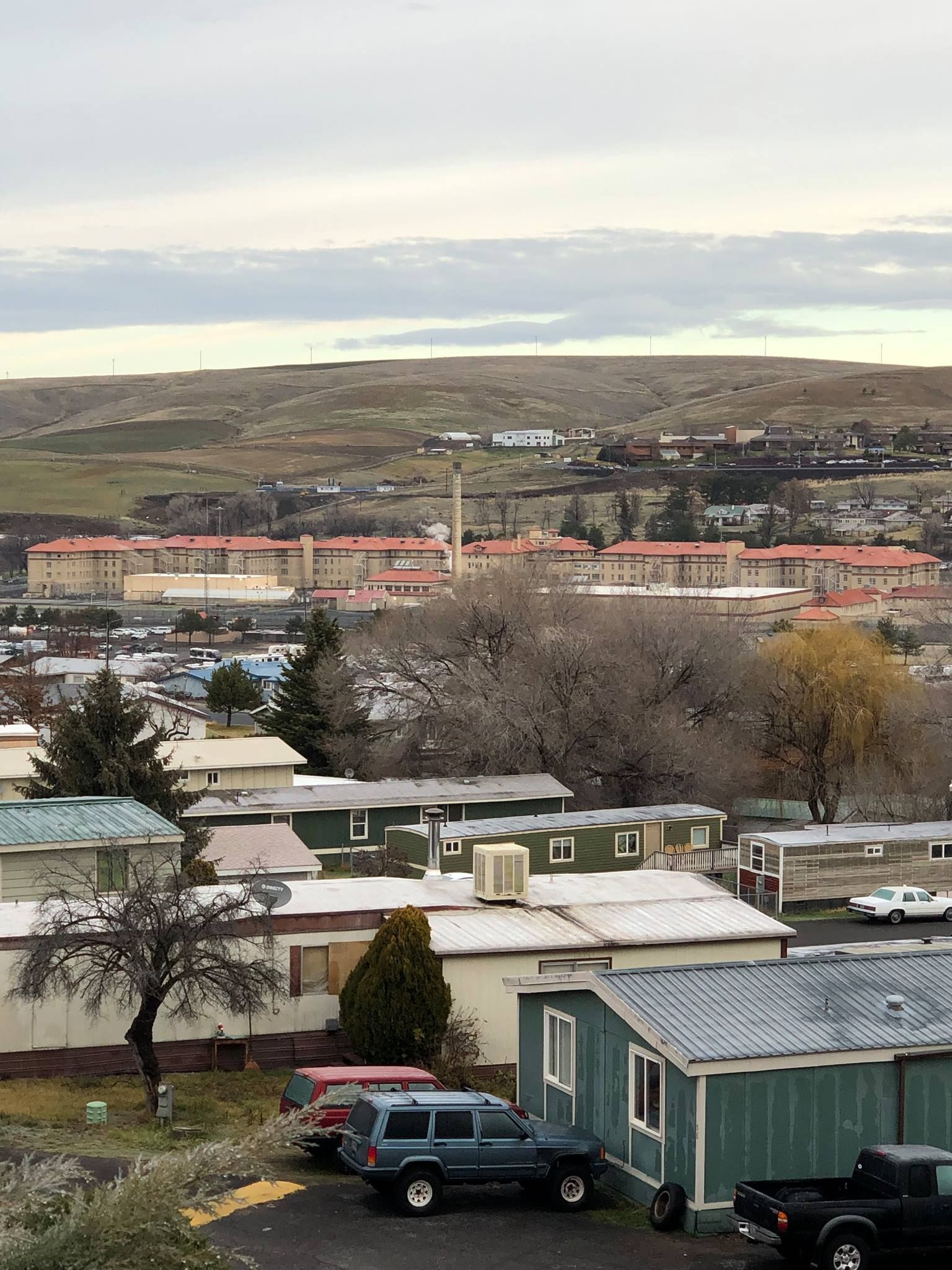 A view of a mobile home park with a city in the background.