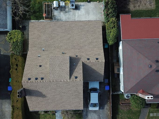 An aerial view of a house with a truck parked in front of it.