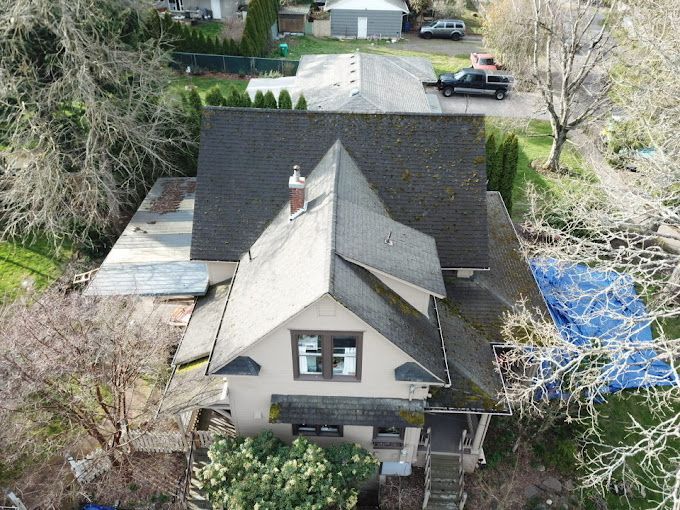 An aerial view of a house with a black roof.