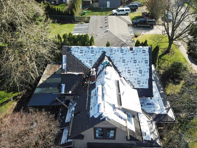An aerial view of a house with a roof being installed.