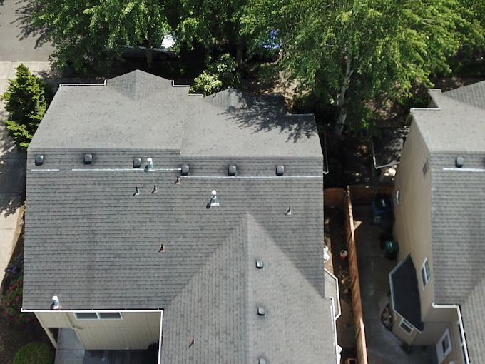An aerial view of a house with a gray roof.