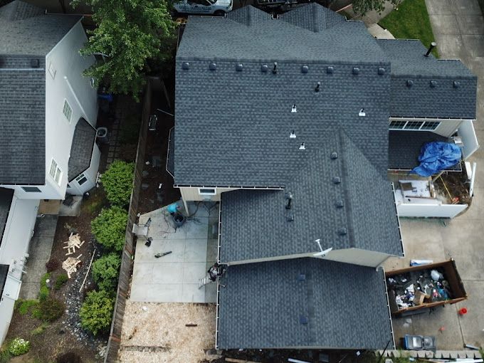 An aerial view of a house with a new roof.