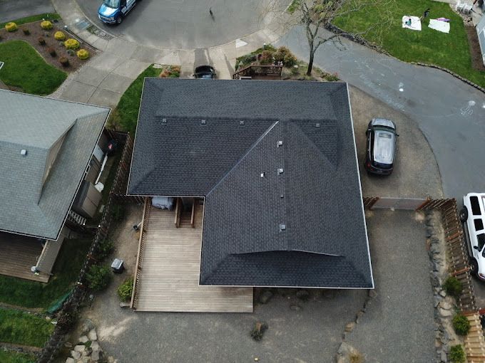 An aerial view of a house with a car parked in front of it.