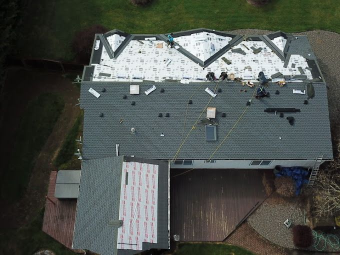 An aerial view of a house with a roof being installed.
