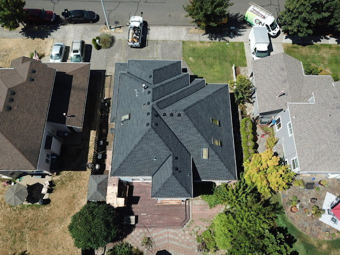 An aerial view of a house in a residential neighborhood.