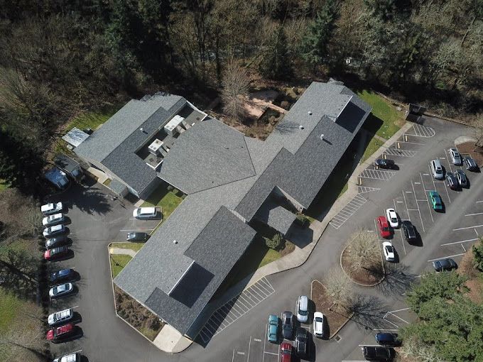 An aerial view of a building with solar panels on the roof.