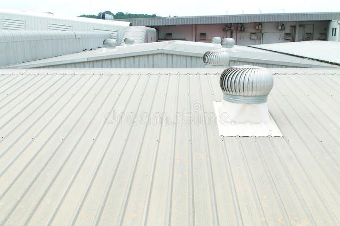 The roof of a building with a fan on it.