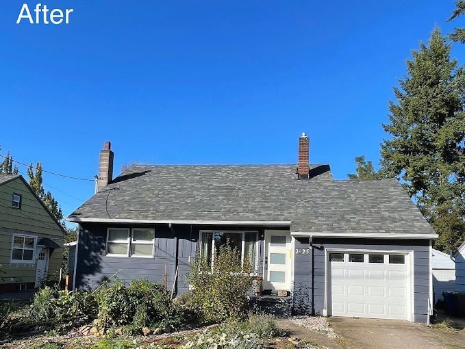 A house with a gray roof and a white garage door.