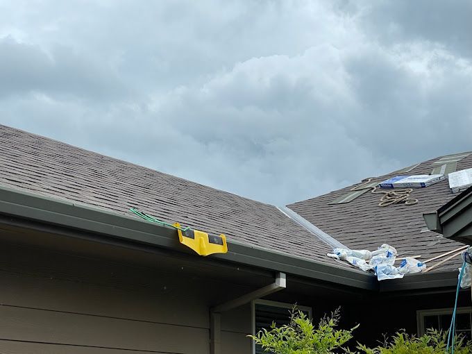 A house with a roof that has been damaged by a storm.