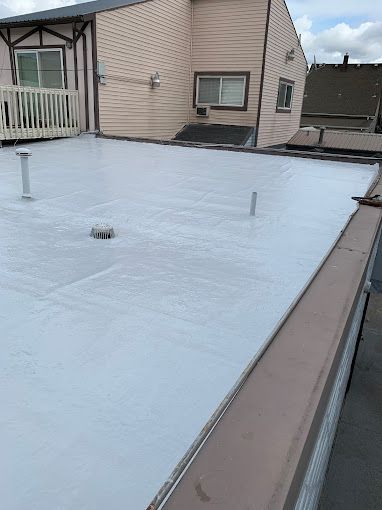 A white roof is sitting on top of a house.