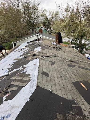 A man is working on the roof of a house.